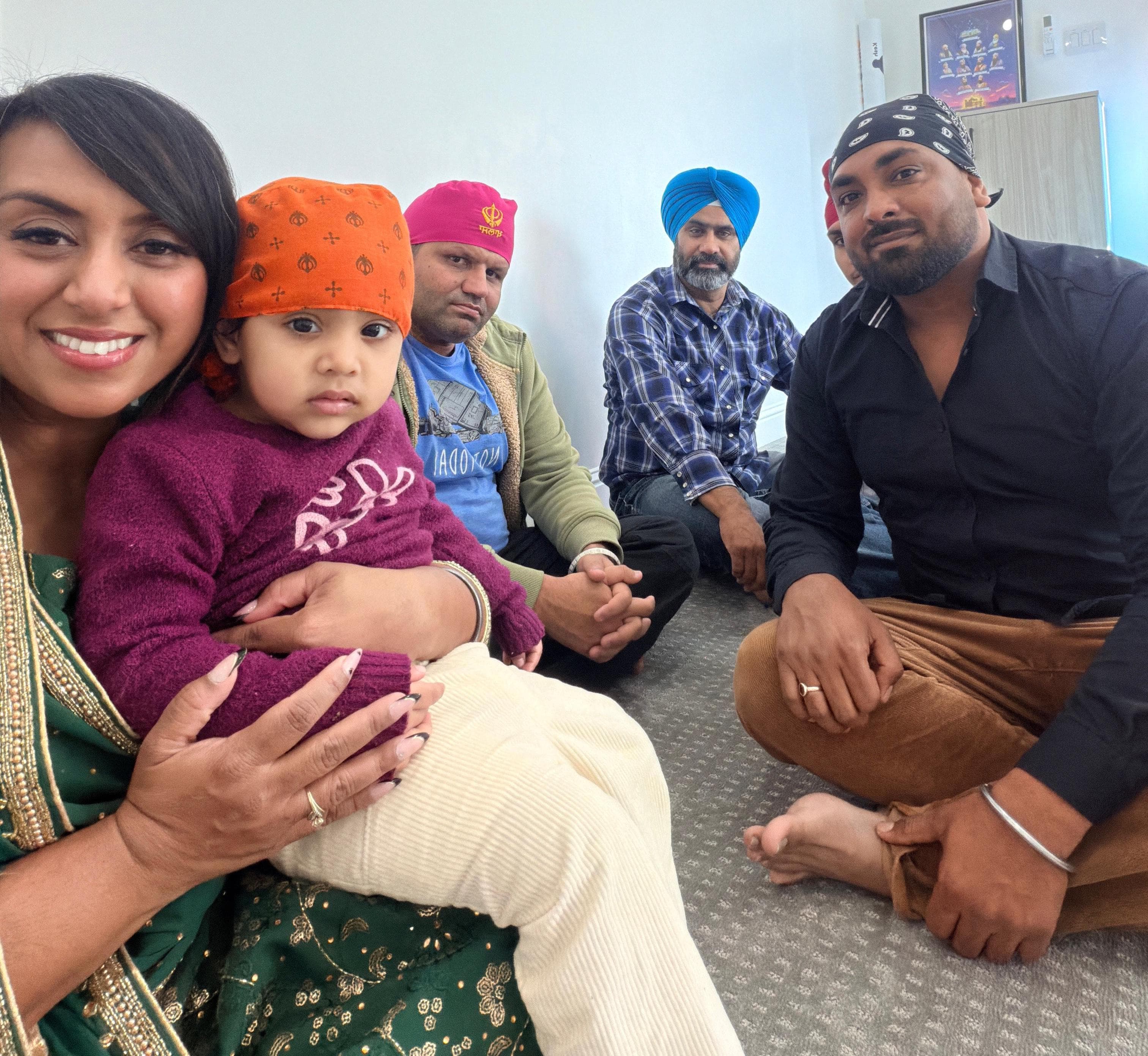 Family and community members seated together at a Gurudwara